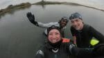In November, three swimmers are still swimming open water