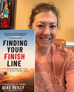 Hilary holding Mike Reilly's book
